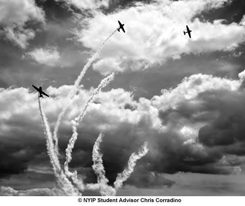 A 17-40mm wide angle lens was used to create a unique perspective. Here, three SNJ-2 planes depart Republic Airport on a cloudy day in Farmingdale, New York.