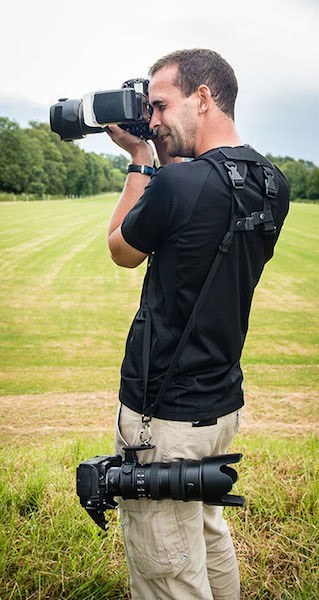 Me, with two cameras hanging off a pair of Black Rapids. It's still not as easy as getting someone else to carry them for you, but it's definitely the best solution I've ever found to preserve my back.